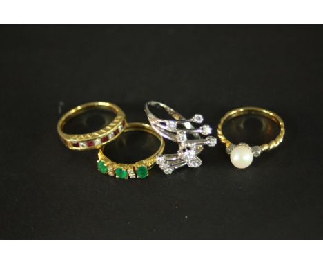 Four gold gem set dress rings. A diamond and white metal  abstract cross over design dress ring (O 1/2), set with eleven roun