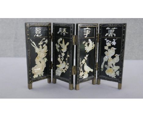 A miniature Japanese mother of pearl and lacquer folding screen. Decorated with birds, cherry blossom and characters. H.22 W.