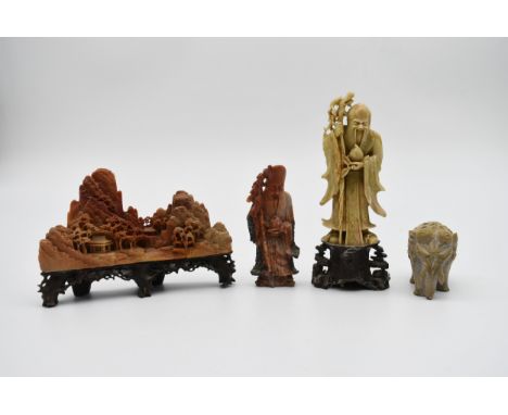 A collection of 20th century Chinese carved soapstone figures. Including a boulder mountain landscape scene on carved and pie