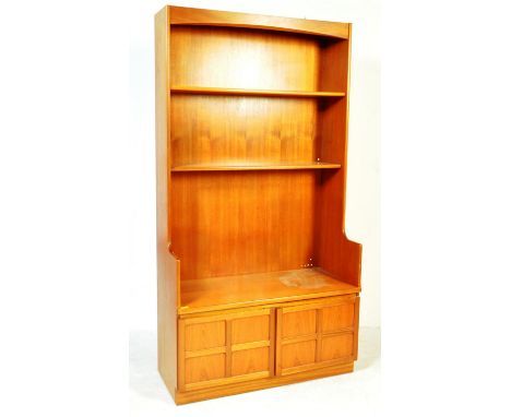 A vintage retro 20th century circa 1970s teak wood veneer wall unit / bookcase cabinet by Nathan of a tall form with fixed sh