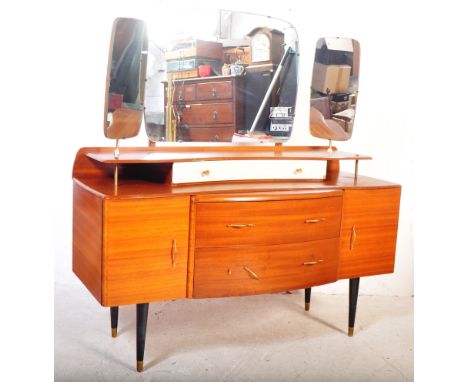 A retro vintage mid 20th century teak dressing chest / dressing table. The dressing chest having trifold mirror back over dre