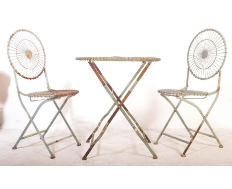 A retro vintage mid 20th Century painted wired industrial patio garden folding table with two chairs. Of circular form with w