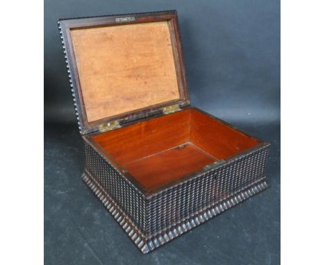 An early 20th century Rosewood box / caddy having rippled moulding to the sides and lid opening to reveal a spacious interior