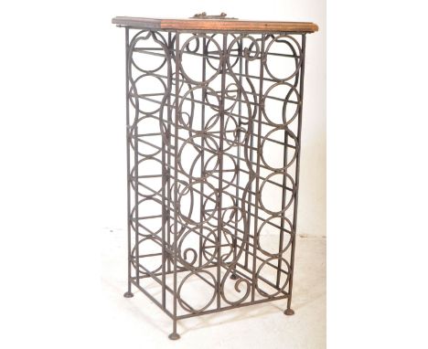 A vintage 20th century free standing metal wine rack having a chamfered edge raised on an ebonised metal frame with carry han