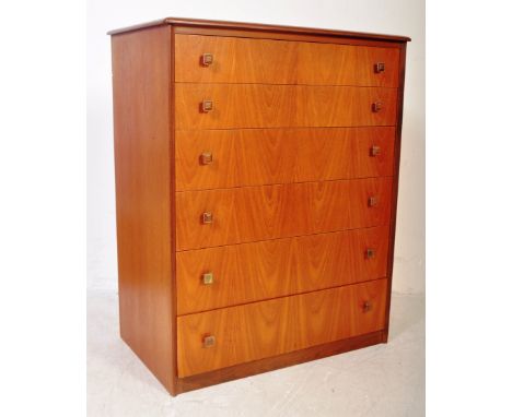 A retro vintage 20th century teak wood chest of drawers. The chest of drawers having a bank of six drawers, all with gilt met