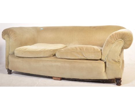 An early 20th century Chesterfield style two seater sofa settee upholstered in a sage green fabric with scrolled armrests and