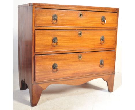 An early 19th century George III mahogany chest of drawers having a bank of three drawers, each with metal moulded lionhead r