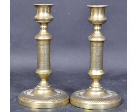 A pair of Victorian brass candle stick holders. With a shaped column with a round beaded base. Measures approx.&nbsp;