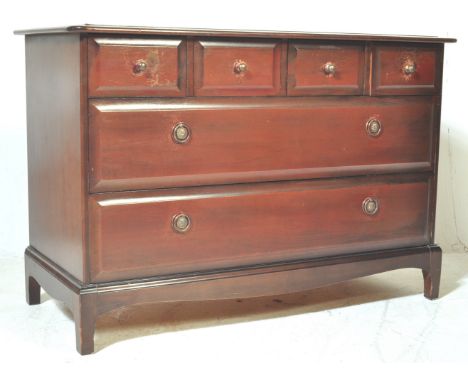 A retro vintage mid 20th century Stag Minstrel African Cherrywood chest of drawers having a flared chamfered edge over a bank