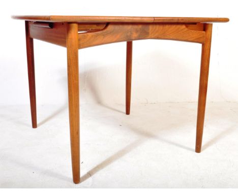 A retro vintage mid 20th Century G Plan extending dining table. Of rectangular form with curved ends with borders raised on c
