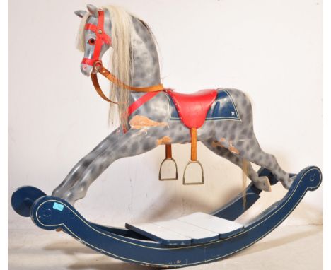 A vintage 20th Century circa 1980s child rocking horse. The wooden horse is grey colourway with red harness and saddle and me