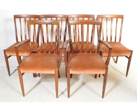 A set of six retro vintage mid 20th Century teak wood dining chairs. Having a curved back rest with vertical slats, upholster