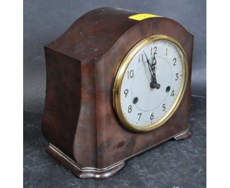 A vintage retro mid 20th century circa. 1940's Smiths bakelite cased mantel clock. The mantle clock having a bow top case wit