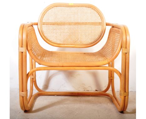 A vintage retro 20th century bamboo and rattan armchair. The armchair having a strapped bamboo frame with rattan panels to ba