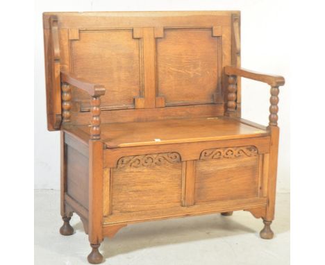 1920's Oak Jacobean revival hall settle - monks bench. Geometric moulded panels with bobbin turned supports having hinged sea