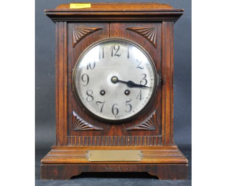 An early 20th century mahogany cased German mantel clock. The mantle clock having silvered face with Arabic numeral to the ch