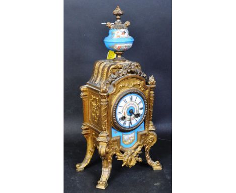 An early 20th century brass and ceramic Sevres style mantel clock having&nbsp; a blue ceramic urn above with hand painted flo