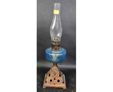 A late 19th century Duplex oil lamp having gilt metal Queen Anne base with pierced foliate decoration and indented blue glass