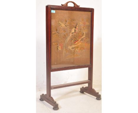 An early 19th century Georgian rise and fall fire screen having a carved foliate handle tapestry fabric of avian subjects rai