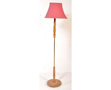 A retro vintage mid 20th century teak wood floor standard lamp being raised on terraced base complete with shade. Measures 15