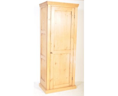 A retro vintage 20th Century single door pine wood wardrobe closet. Having a flared top, single door with circular metal pull