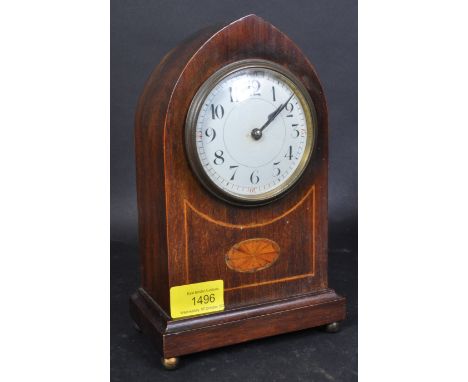 An Edwardian early 20th century circa. 1900's inlaid mahogany mantel clock. The mantle clock having white face with black Ara