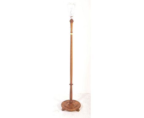 Edwardian mahogany floor standing standard lamp. The lamp being raised on scroll terminal feet with circular base having turn