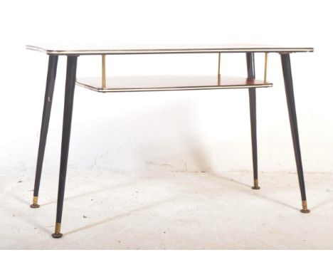 A vintage retro mid 20th century circa. 1960's coffee table having wood effect rectangular top with lower tier beneath raised