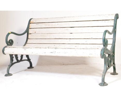 A 20th century garden bench having painted bench ends in a green colourway, scrolled elbow rests with a white slatted seat.