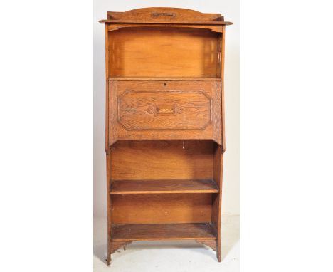 An early 20th century Arts and Crafts manner oak students bureau having shelf over a fall front desk top opening to reveal ap