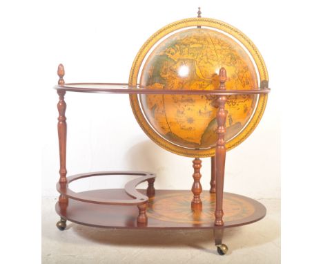 A vintage retro 20th century globe drinks cocktail trolley having a printed paper map transfer with globe to centre opening t