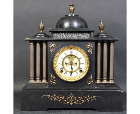 A 19th century Victorian slate mantel clock. The face being enamelled in white chapter ring with roman numeral with exposed m