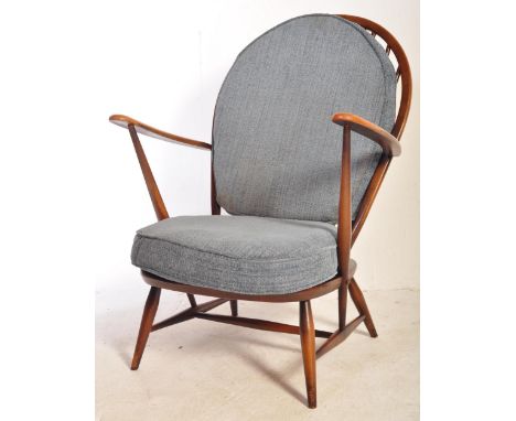Ercol - British Designer - A mid 20th Century retro vintage dark stained beech and elm wood Windsor arm chair. Having hoop sp