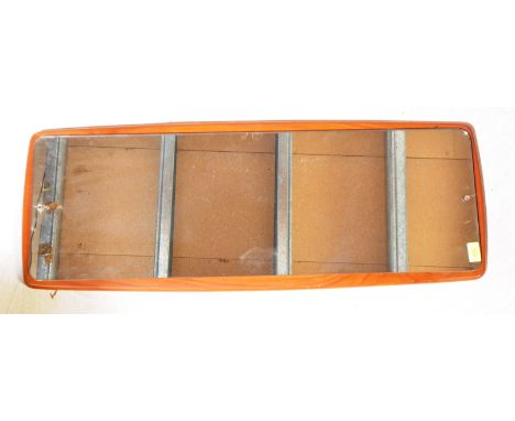 A vintage retro mid 20th century atomic style teak wall mirror having shaped wood back and mirror glass to centre with facete