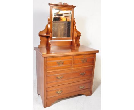 An Edwardian early 20th century circa. 1900's satin walnut dressing chest. The chest having a single swing mirror with carved