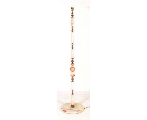 A retro vintage mid 20th Century circa 1950s Hollywood regency gilt brass and onyx floor standing standard lamp. Having a lon