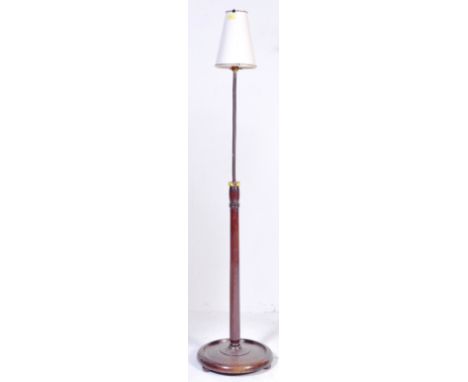 A vintage retro mid 20th century circa. 1970's standard floor standing lamp. The lamp having tapering wooden shaft over a cir