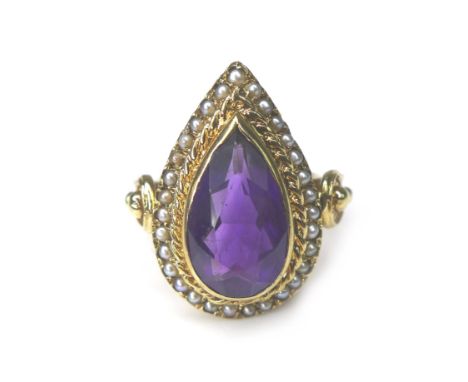 An amethyst and seed pearl 9ct gold dress ring, pear cut amethyst 8 by 14mm, encircled by seed pearls, ring size O/P, 10.6g. 