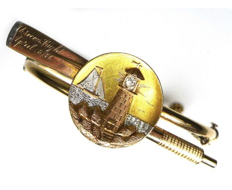 A Victorian rose gold bangle, in the form of of an oar with white gold tipped blade surmounted by a circular plaque, relief e