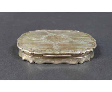 A Victorian silver case, of oval form with scalloped rim and hinged cover, engraved foliate decoration over engine turned row
