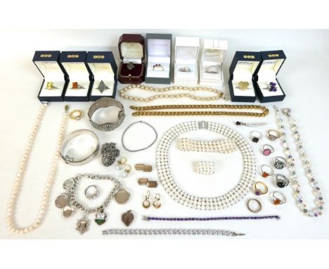 A collection of costume jewellery, including a quantity of dress rings, a silver bangle and charm bracelet, approximately 2.4