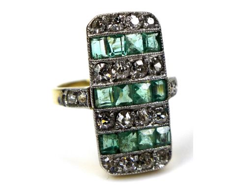 An 18ct yellow gold ring, set with diamonds and emeralds in seven alternating rows within a rectangular setting, each old cut