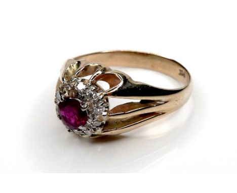A 9ct yellow ring ring, set with an older mounting centred by a 5.0mm ruby surrounded by diamonds, size S, 5.5g. 