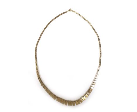 A yellow metal Cleopatra style necklace, with graduated rectangular panels, bearing an indistinct marks '..K' to one end chai