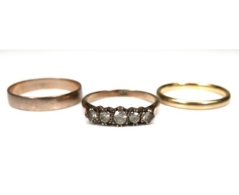 A group of three gold rings, comprising an 18ct gold wedding band, 2.5mm wide, size P, 2.7g, a 9ct gold wedding band, 3.7mm w