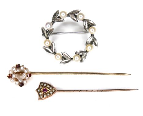 Two pearl mounted stick pins, comprising a 9ct gold ruby and pearl stick pin, 0.8g, a yellow metal garnet and pearl mounted s