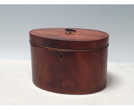A Georgian mahogany oval Tea Caddy with crossbanded and fan inlaid top, enclosing two divisions, 8in W 