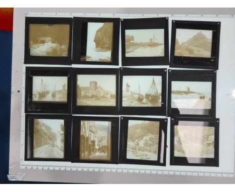 Two cases of Magic Lantern Slides including coastal and street views (possibly Devon/Cornwall) and tring 