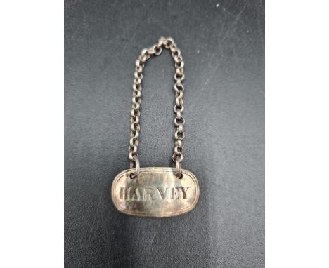A George IV silver Harvey Label, London 1821, maker: W.E, another Harvey Label and silver Scotch label, London 1976 
