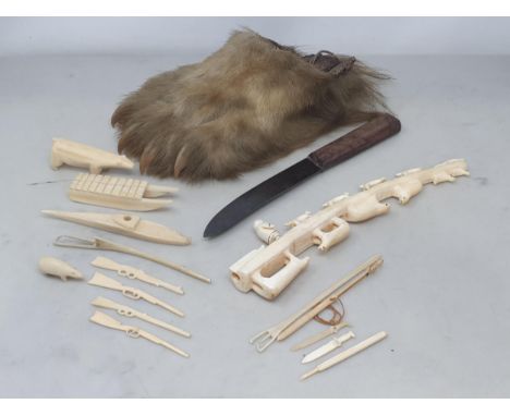 A collection of walrus ivory Inuit Artefacts to include carved figure group of Huskies, Ermine, Bears and Walrus, a carved To